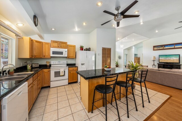 office featuring ceiling fan with notable chandelier, high vaulted ceiling, and light hardwood / wood-style flooring