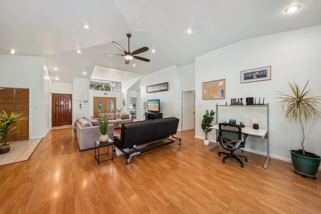 bedroom with vaulted ceiling, ensuite bath, multiple windows, and ceiling fan