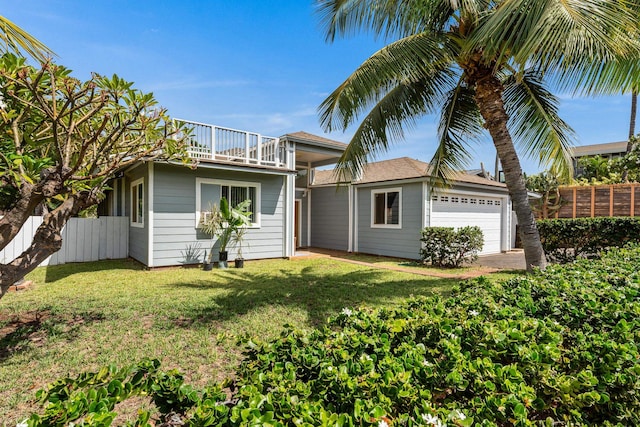 view of front of property with a garage, a balcony, and a front lawn