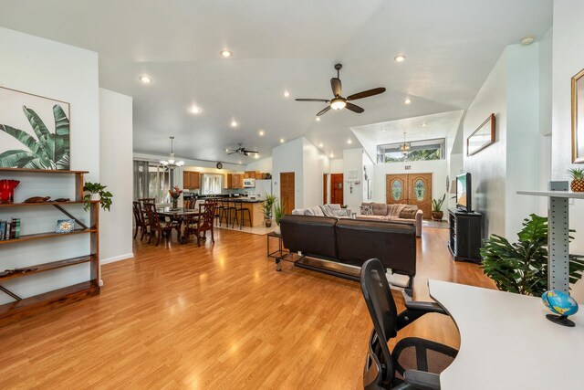 bedroom with light hardwood / wood-style floors, ceiling fan, and lofted ceiling