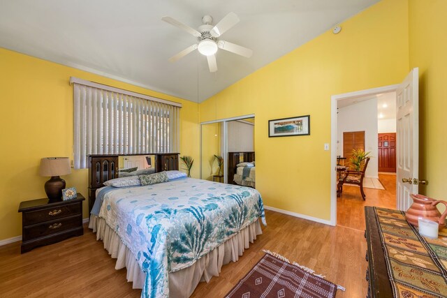 bedroom with multiple windows, a closet, light hardwood / wood-style flooring, and ceiling fan