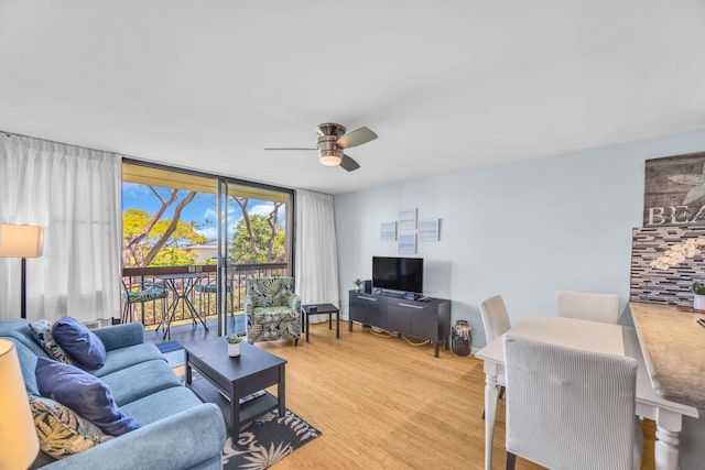 living room featuring ceiling fan and light wood finished floors