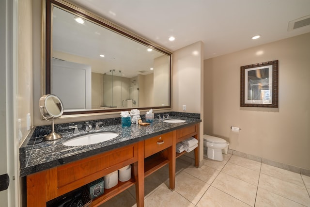 bathroom featuring tile patterned flooring, vanity, and toilet