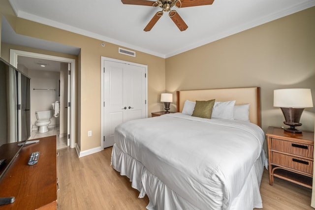 bedroom featuring ceiling fan, light wood-type flooring, ornamental molding, connected bathroom, and a closet