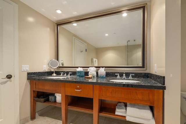 bathroom with tile patterned flooring, vanity, and toilet