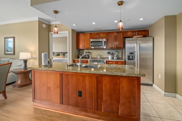 kitchen with ornamental molding, sink, pendant lighting, and appliances with stainless steel finishes