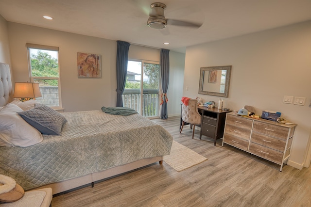 bedroom with access to exterior, recessed lighting, multiple windows, and light wood finished floors