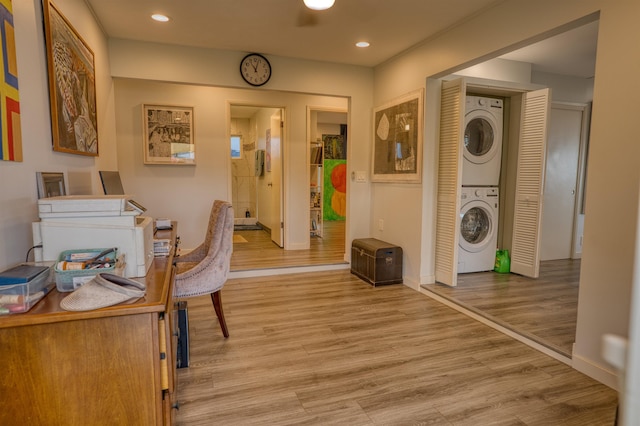 office area featuring stacked washer and dryer, baseboards, recessed lighting, and light wood finished floors