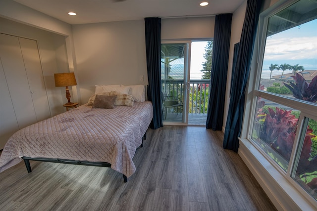 bedroom featuring access to outside, wood finished floors, and recessed lighting