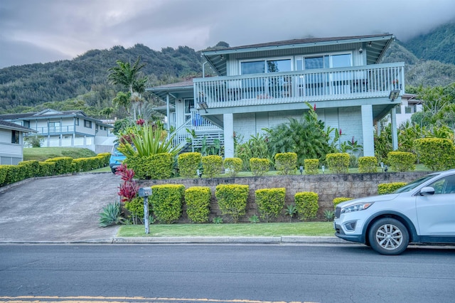 view of front of home with a mountain view and stairway
