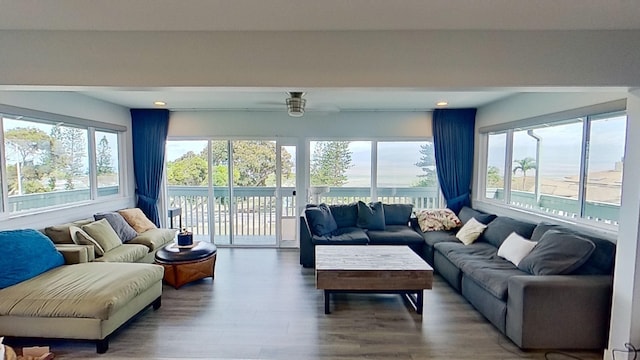 living area featuring plenty of natural light, wood finished floors, recessed lighting, and a ceiling fan