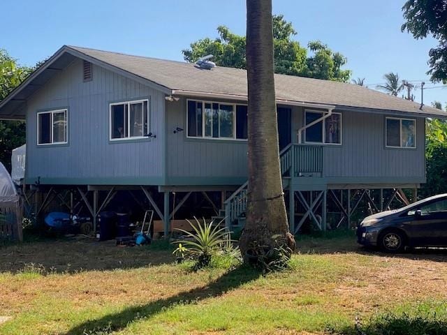 rear view of house with a yard