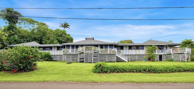 view of front facade with stairway and a front yard