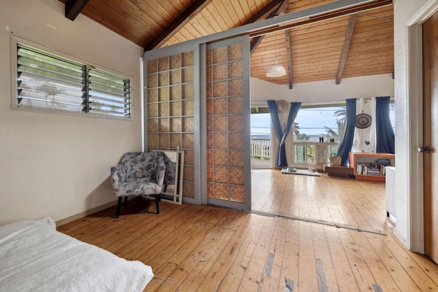 interior space featuring vaulted ceiling with beams, hardwood / wood-style flooring, wood ceiling, and access to outside