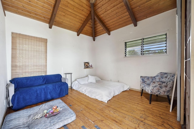 bedroom with lofted ceiling with beams, wood ceiling, and hardwood / wood-style flooring