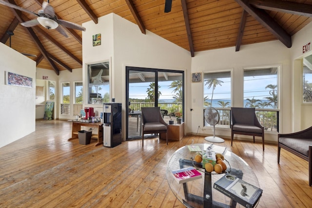 living area with high vaulted ceiling, wood-type flooring, plenty of natural light, and ceiling fan