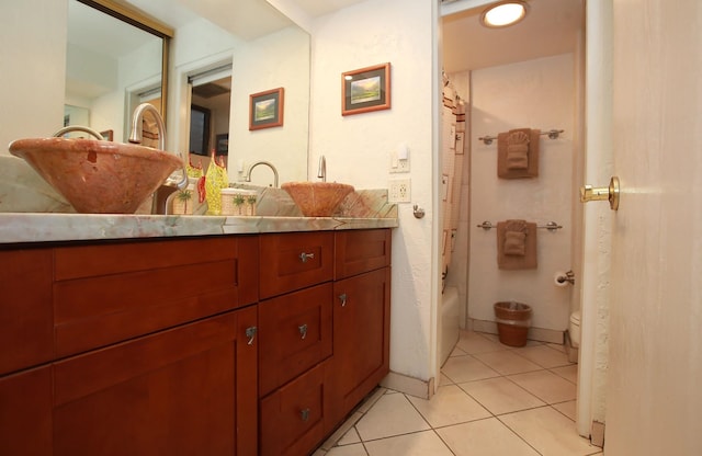 full bathroom featuring tile patterned floors, shower / bath combo with shower curtain, vanity, and toilet