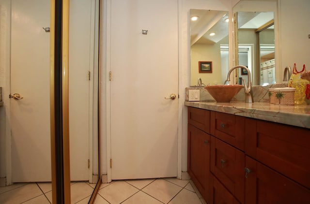 bathroom with tile patterned flooring and vanity