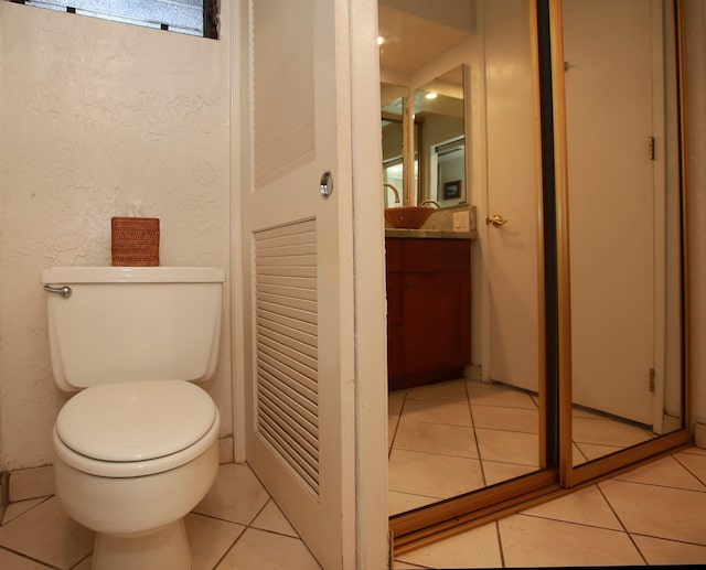 bathroom featuring tile patterned floors, vanity, and toilet