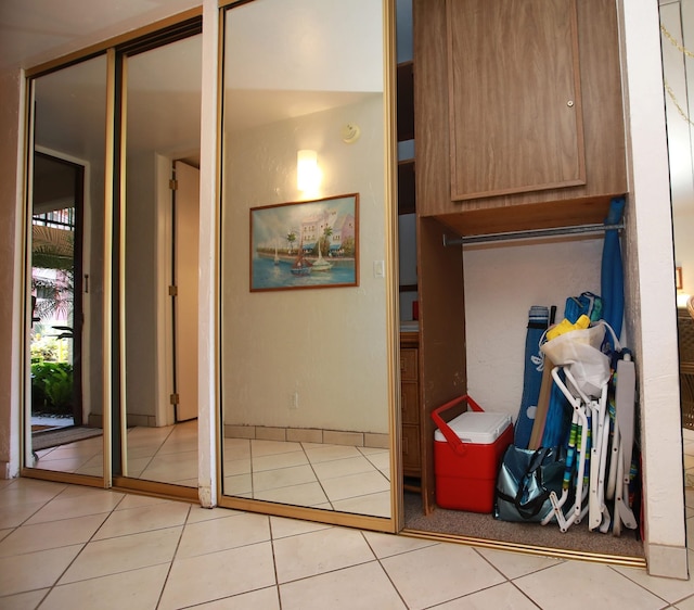 hallway featuring light tile patterned flooring