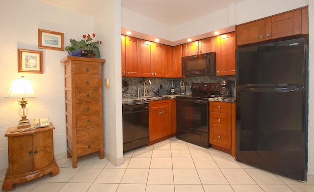 kitchen featuring backsplash, sink, light tile patterned floors, and black appliances