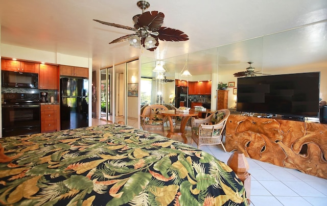 interior space featuring decorative backsplash, light tile patterned floors, ceiling fan, and black appliances