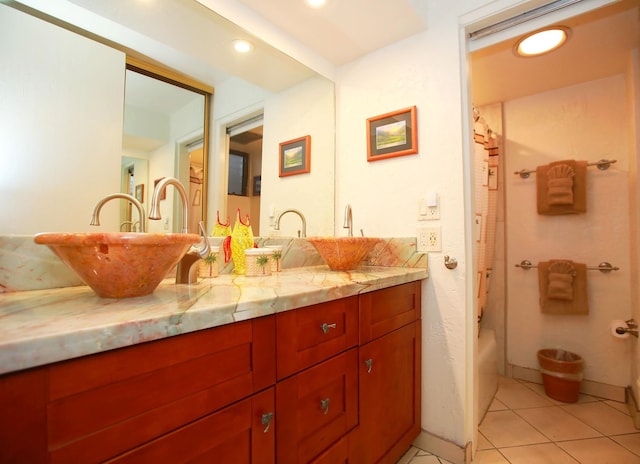 bathroom featuring tile patterned flooring, shower / bath combination with curtain, and vanity