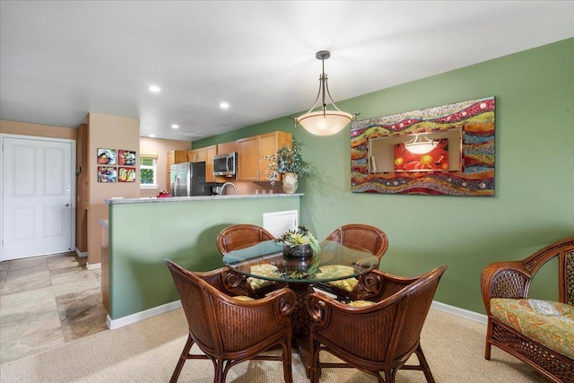 dining space with baseboards, recessed lighting, and light carpet