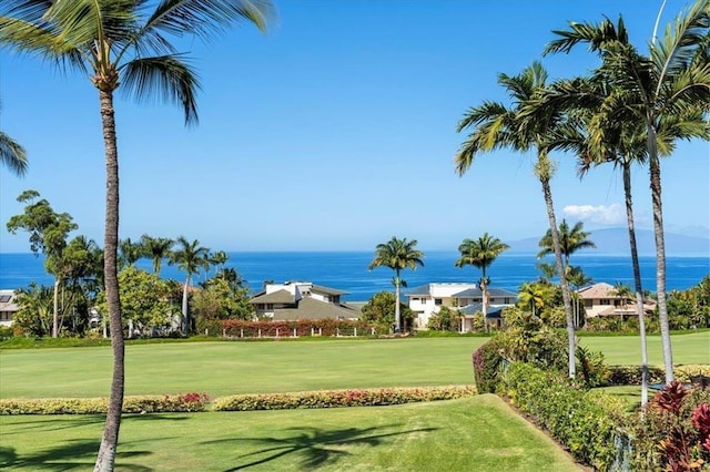 view of community with a lawn, a water view, and golf course view