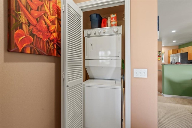 laundry area with carpet flooring, recessed lighting, laundry area, and stacked washing maching and dryer
