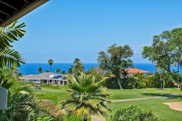 view of home's community with a lawn and a water view