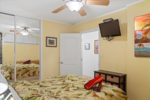 bedroom with a closet, a ceiling fan, and ornamental molding