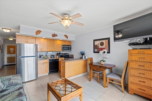 kitchen with a ceiling fan, appliances with stainless steel finishes, a sink, a peninsula, and light tile patterned flooring