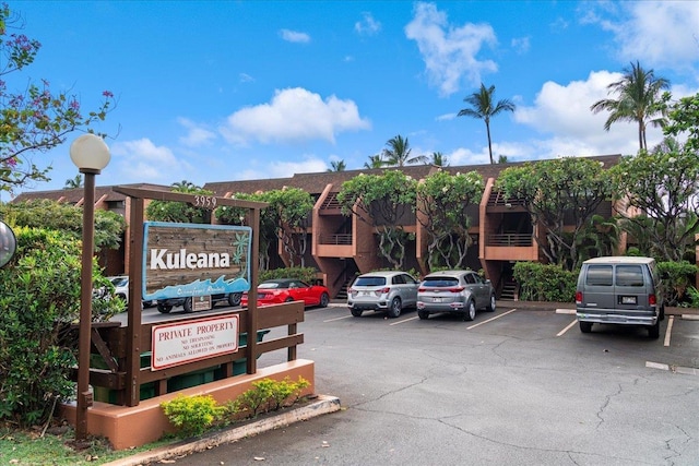 view of building exterior featuring uncovered parking