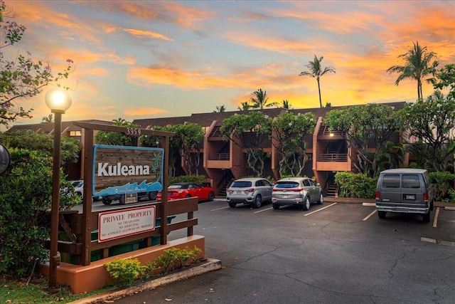 property at dusk with uncovered parking