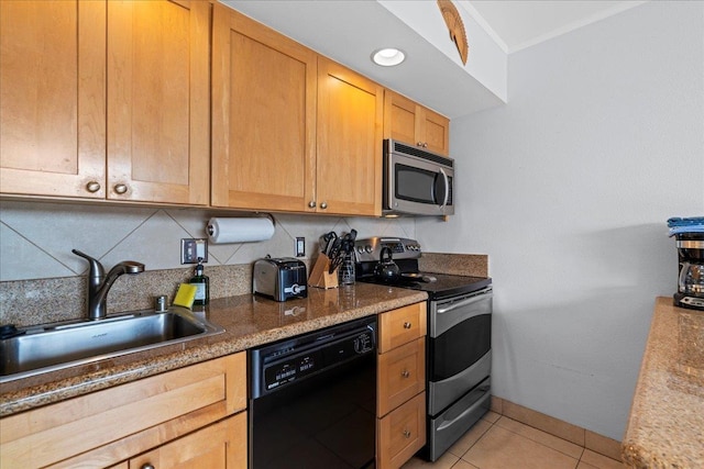 kitchen with decorative backsplash, appliances with stainless steel finishes, a sink, baseboards, and light tile patterned floors