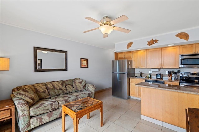 kitchen with stainless steel appliances, a ceiling fan, light tile patterned flooring, and a sink