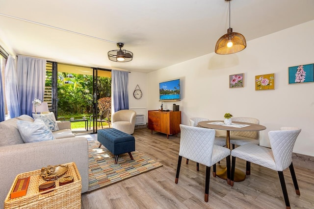 living room featuring light wood-type flooring and expansive windows