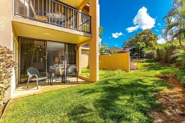 view of yard featuring a patio area and a balcony