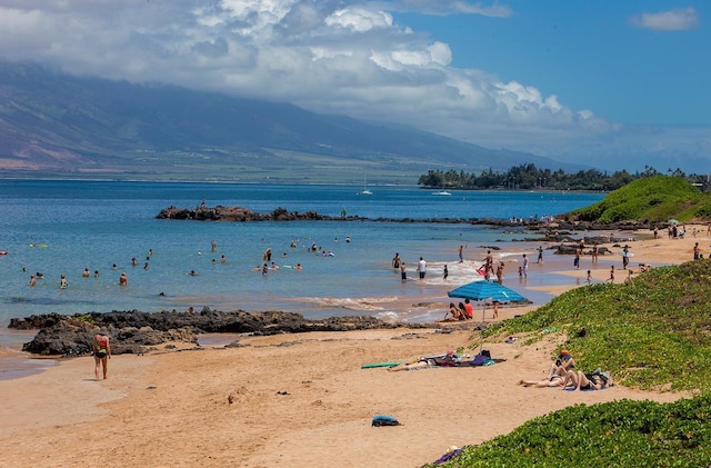 view of water feature featuring a mountain view and a beach view