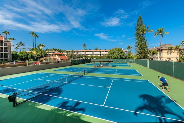 view of tennis court featuring basketball hoop