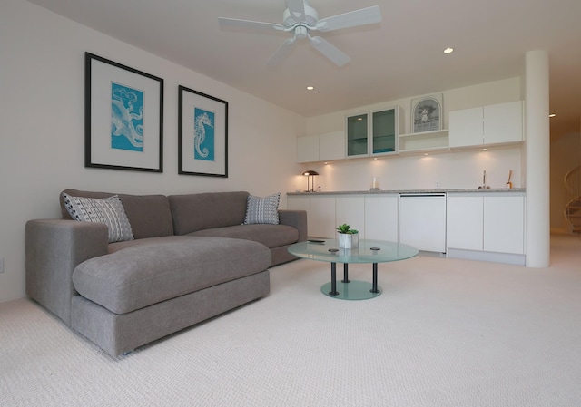 living area with light carpet, wet bar, a ceiling fan, and recessed lighting