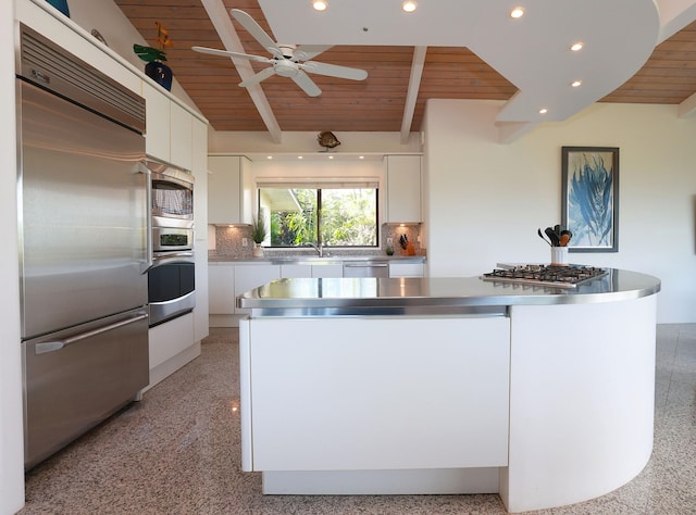 kitchen featuring stainless steel countertops, white cabinets, built in appliances, wooden ceiling, and beamed ceiling