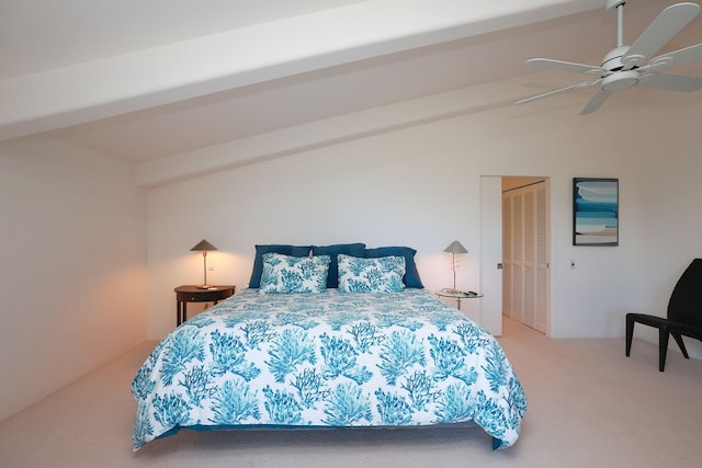 bedroom featuring carpet, a closet, vaulted ceiling, and ceiling fan