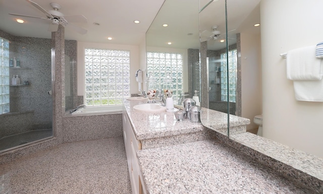 full bathroom featuring toilet, a stall shower, vanity, and a ceiling fan