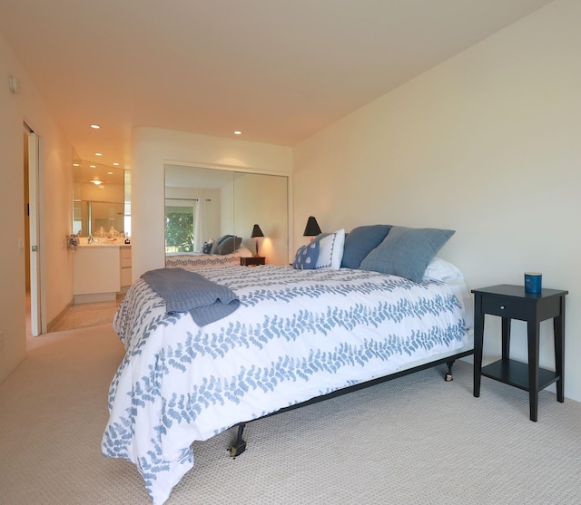 bedroom featuring a closet, carpet, connected bathroom, and recessed lighting