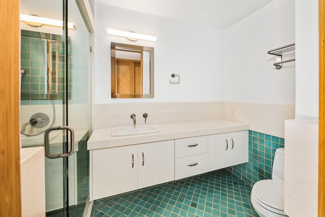 bathroom with vanity, tile patterned flooring, toilet, tile walls, and an enclosed shower