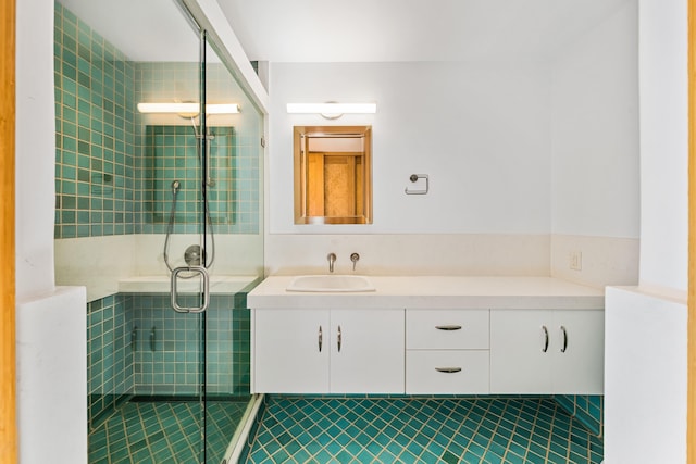 bathroom with tile patterned flooring, vanity, and a shower with shower door