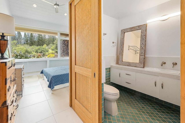 bathroom featuring tile patterned flooring, vanity, and toilet