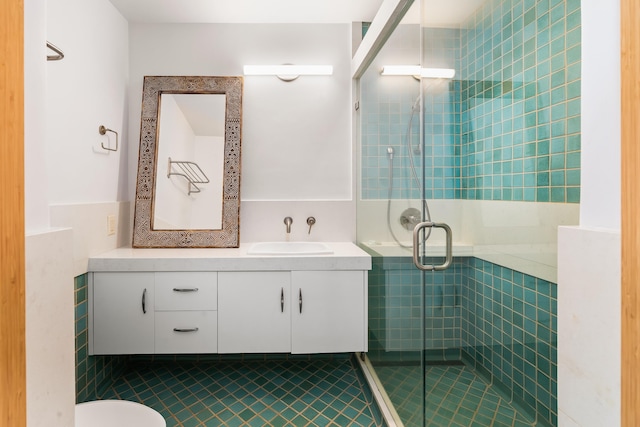 bathroom with tile patterned floors, vanity, and a shower with shower door